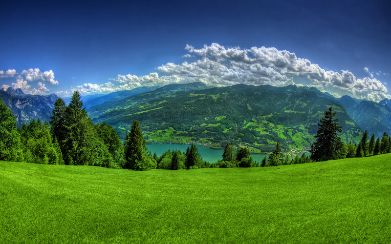 Green valley with lake and mountains