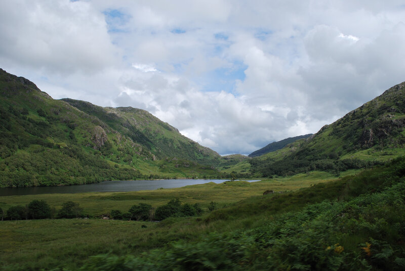 green valley with lake and mountains
