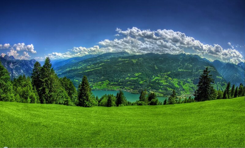 Green valley with lake and mountains