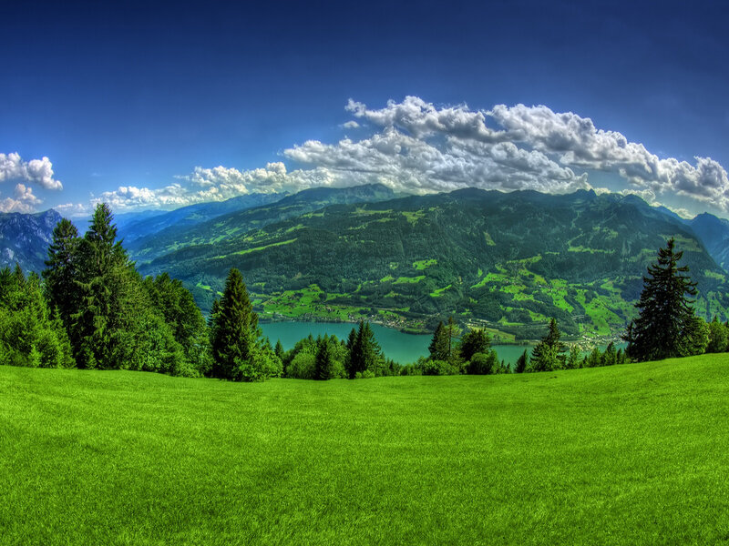 Green valley with lake and mountains