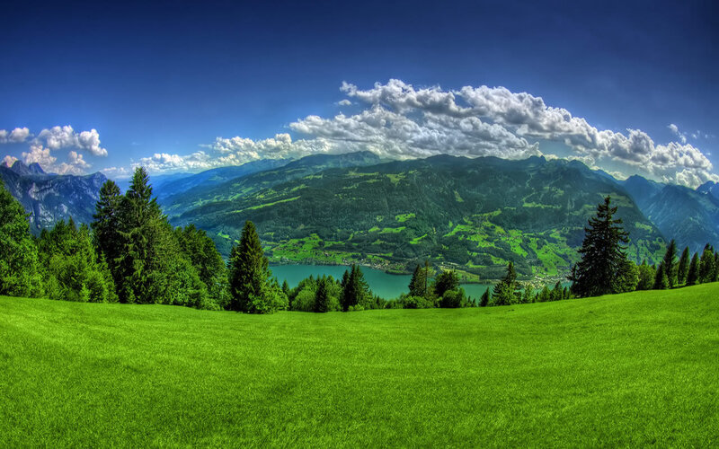 Green valley with lake and mountains