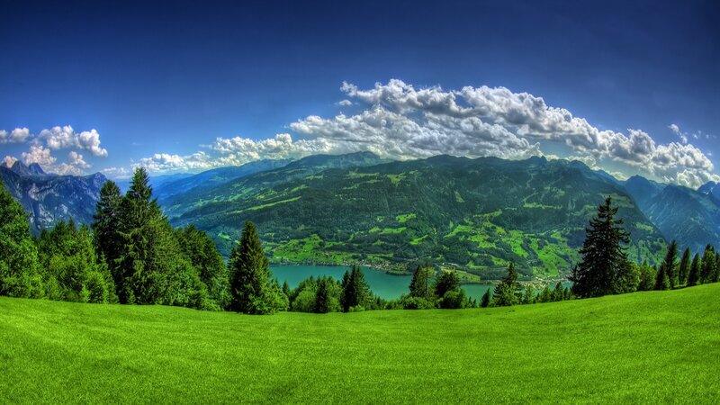 Green valley with lake and mountains