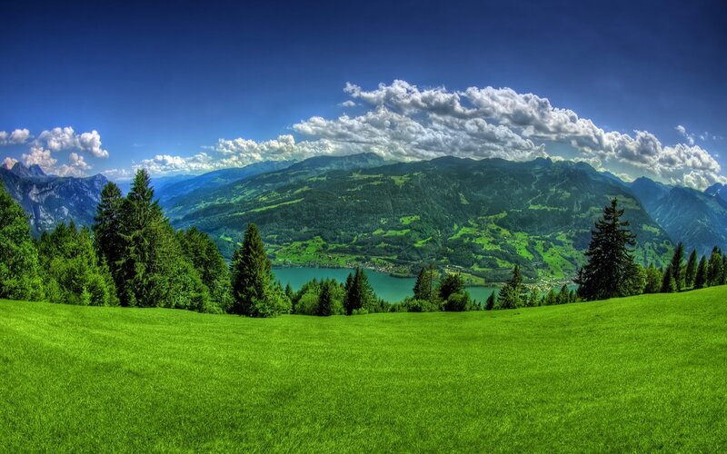 Green valley with lake and mountains