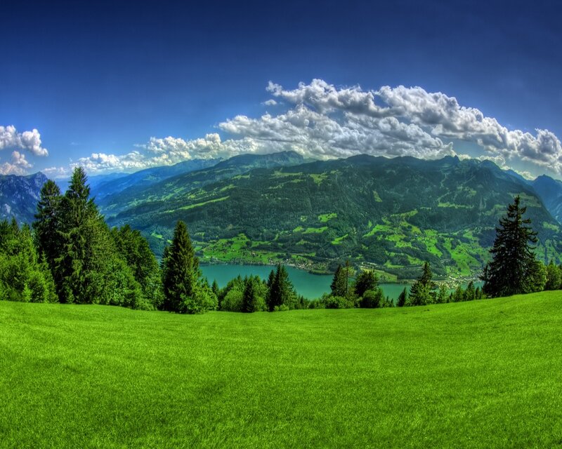 Green valley with lake and mountains
