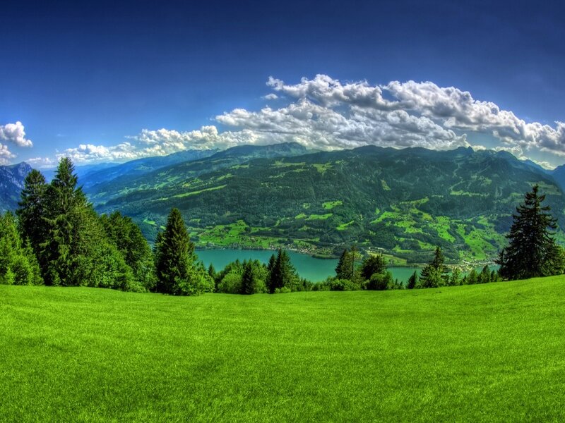Green valley with lake and mountains