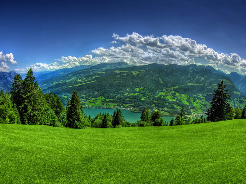 Green valley with lake and mountains