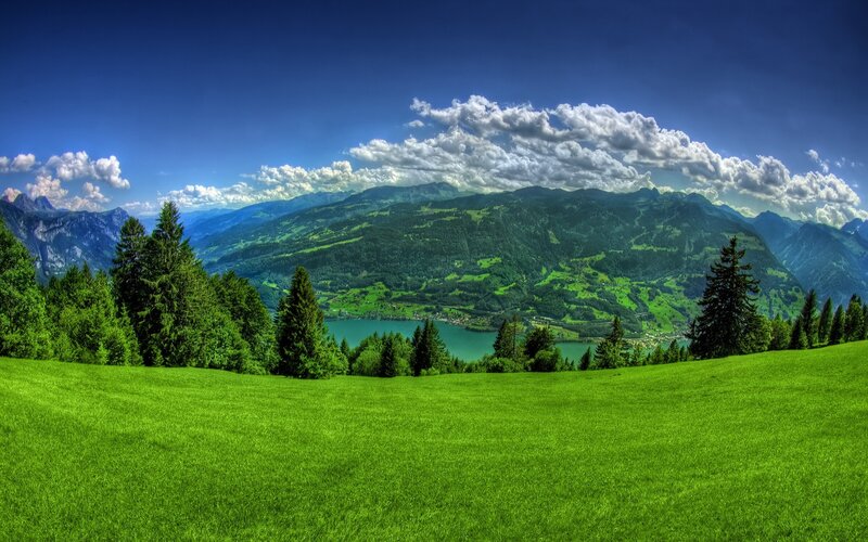 Green valley with lake and mountains