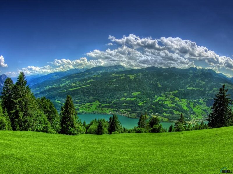 Green valley with lake and mountains