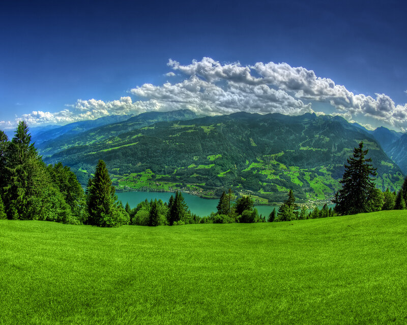 Green valley with lake and mountains