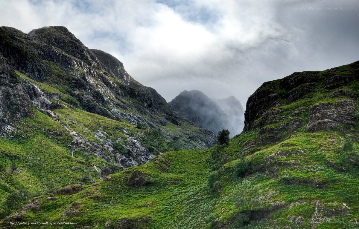 Green valley with misty mountains