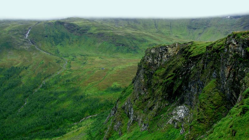green valley with river and cliffs