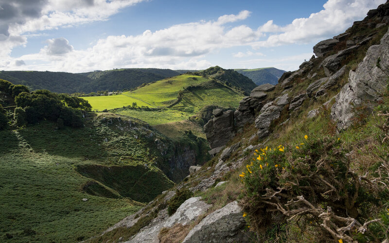 Green Valley with Rocky Cliff — Serene