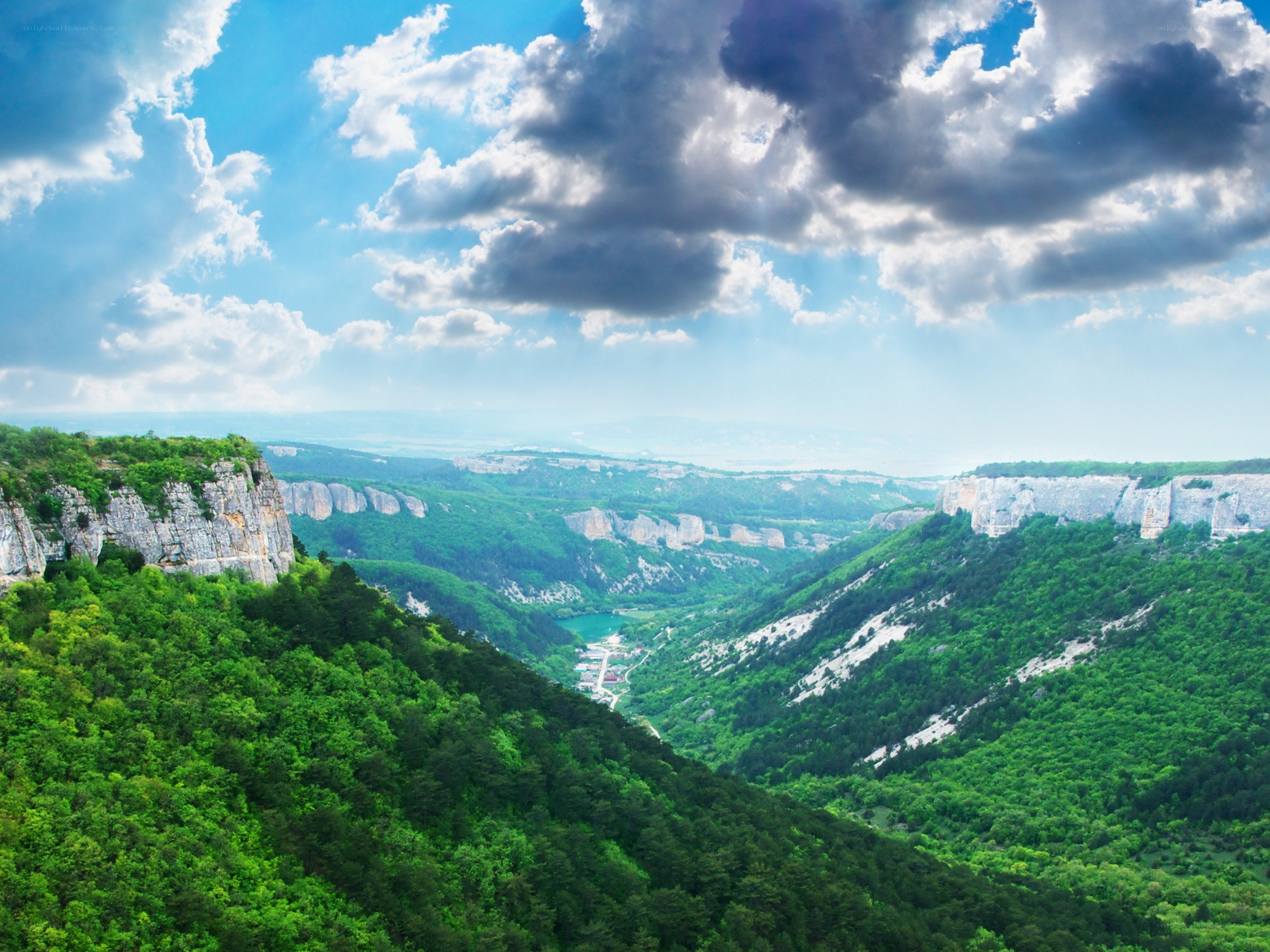 Green valley with rocky cliffs