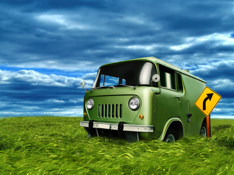 Green van in a grassy field