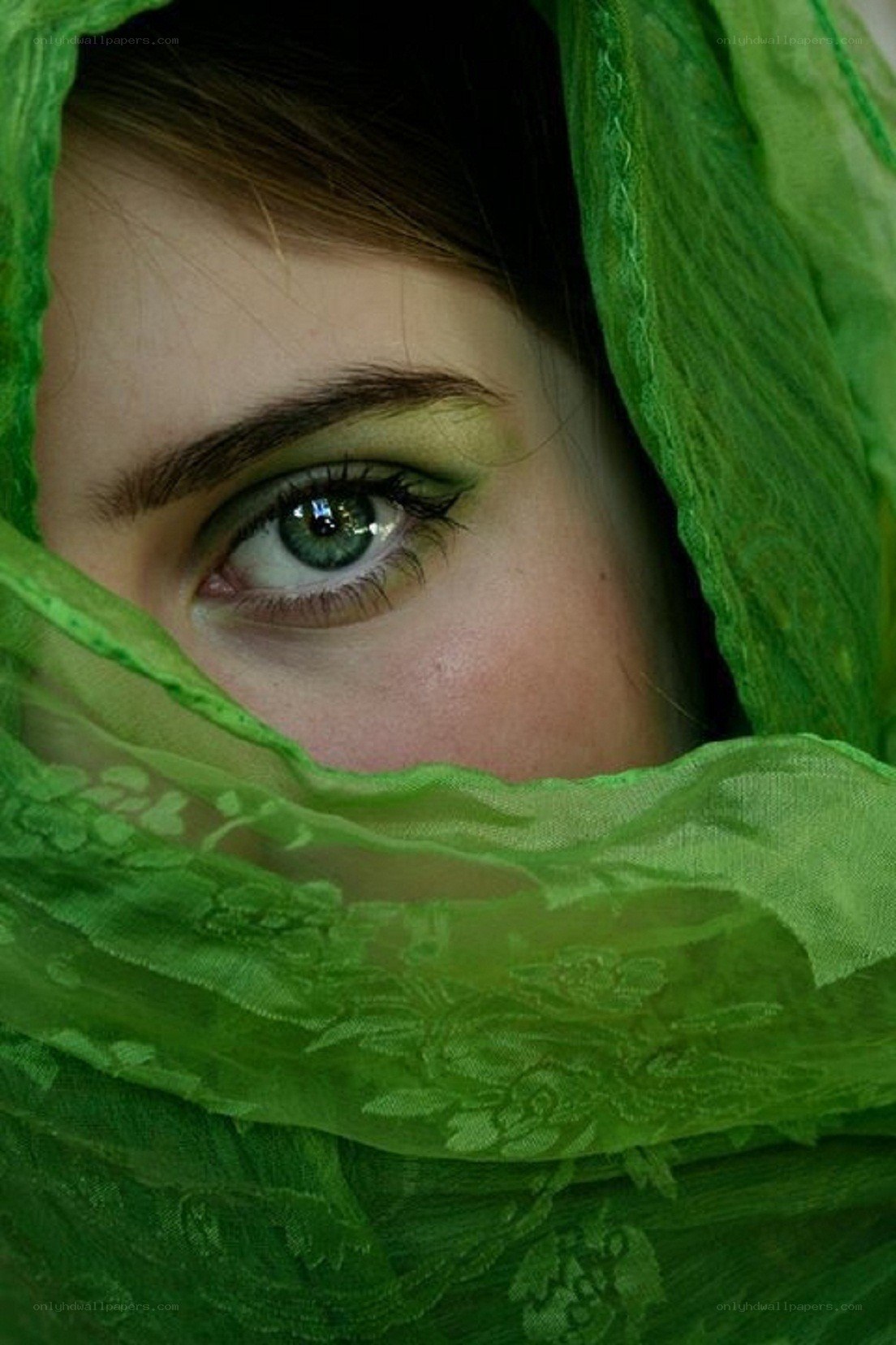 green veil covering eye