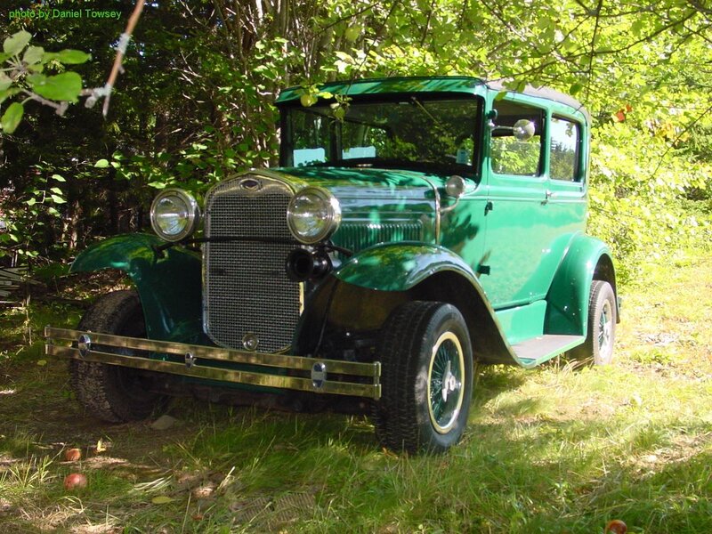 Green vintage car in forest