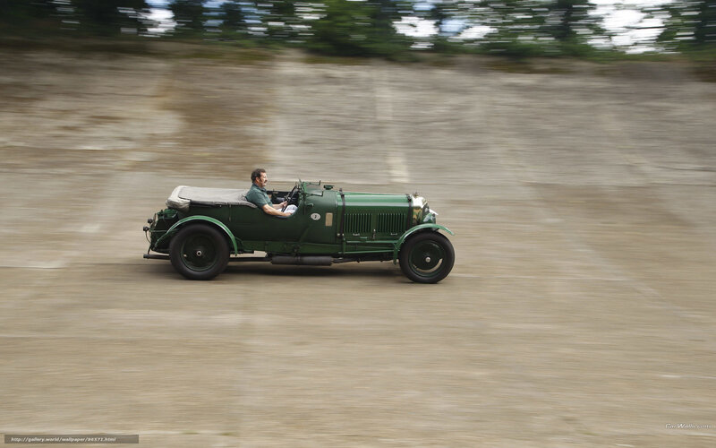 Green vintage car in motion