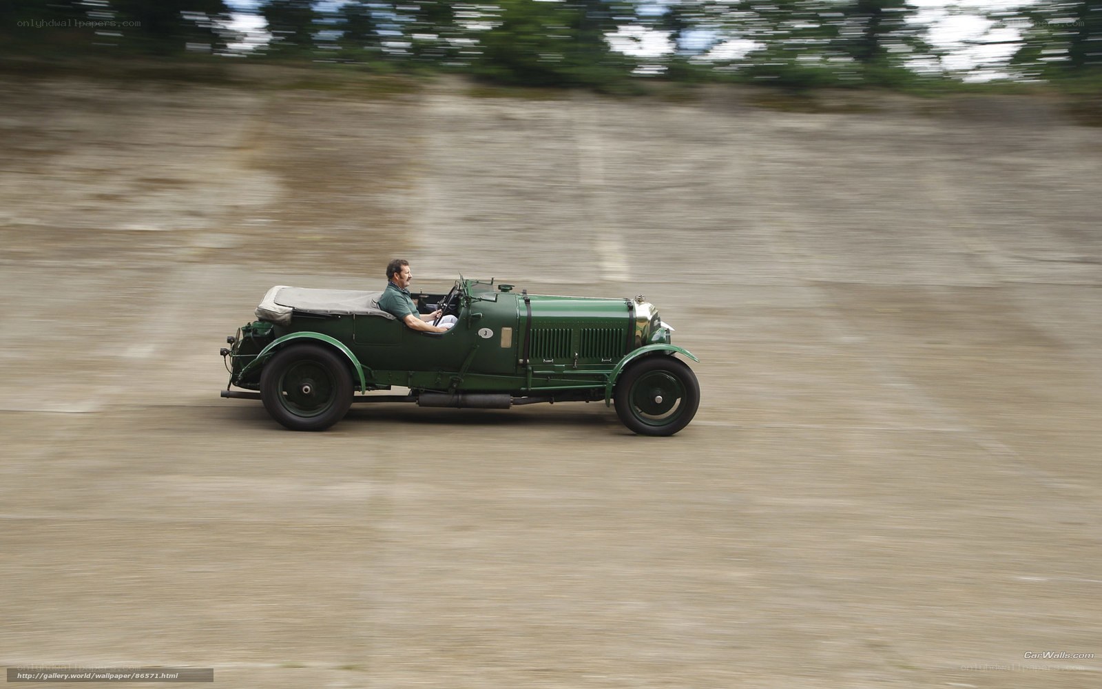 Green vintage car in motion