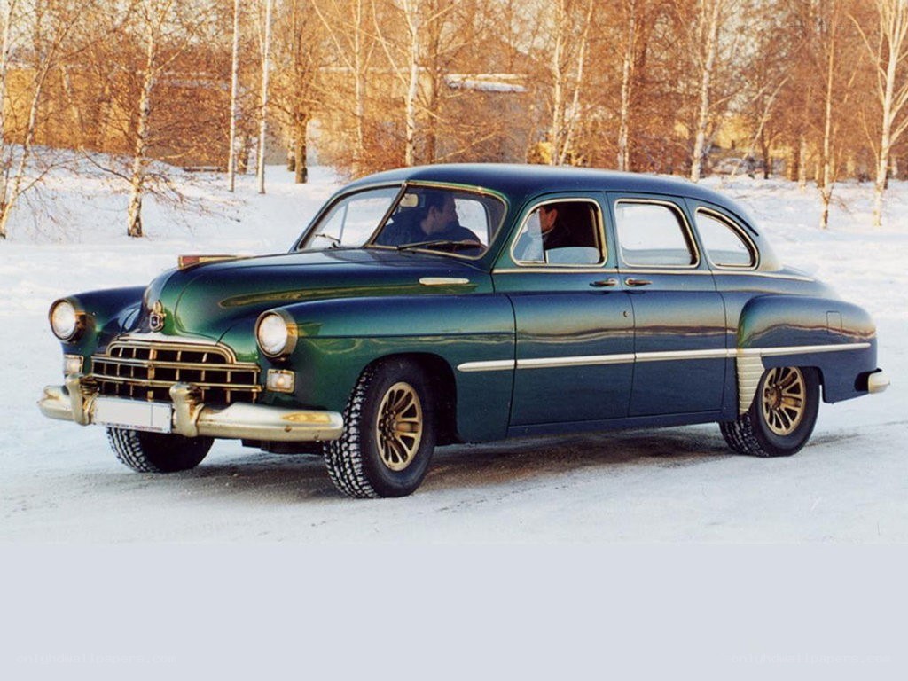 Green vintage car in snow