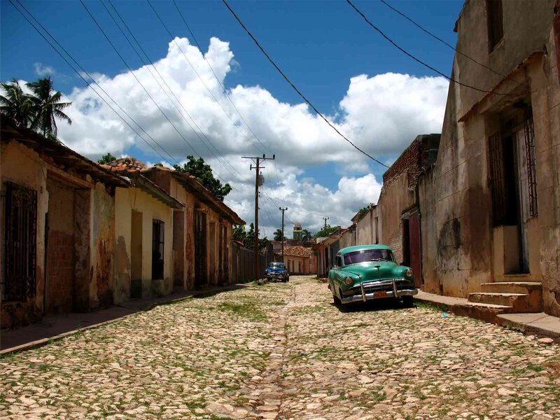 Green Vintage Car on Cobblestone