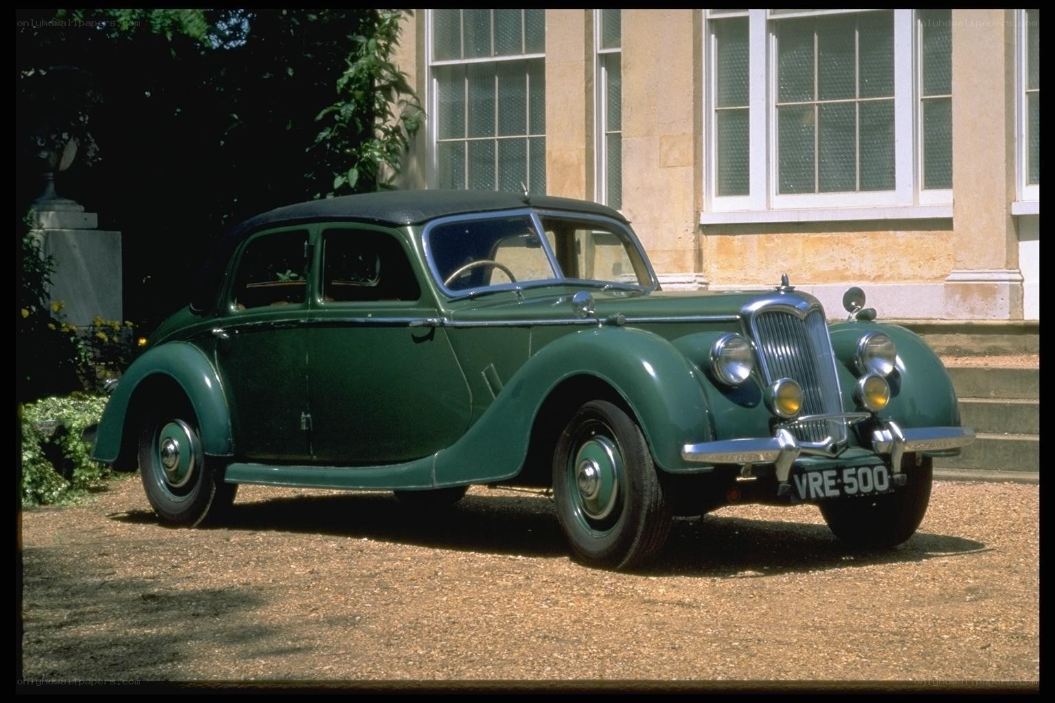 Green vintage car parked
