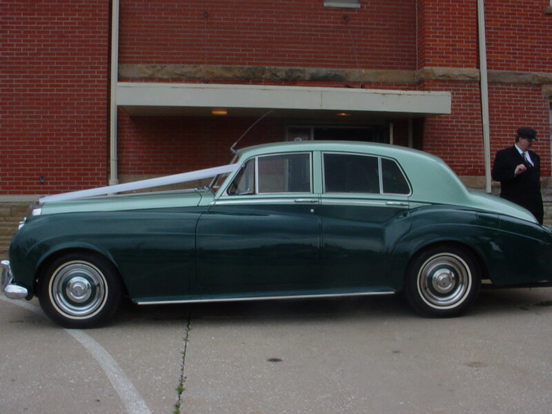 Green vintage car with ribbon