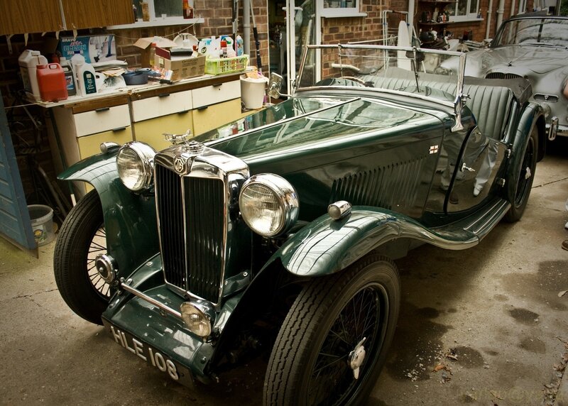 Green vintage MG car in garage