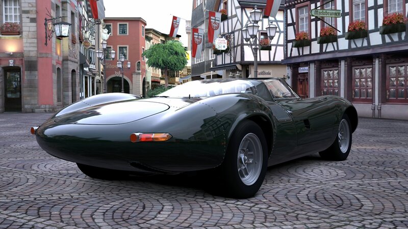 Green vintage race car on cobblestones