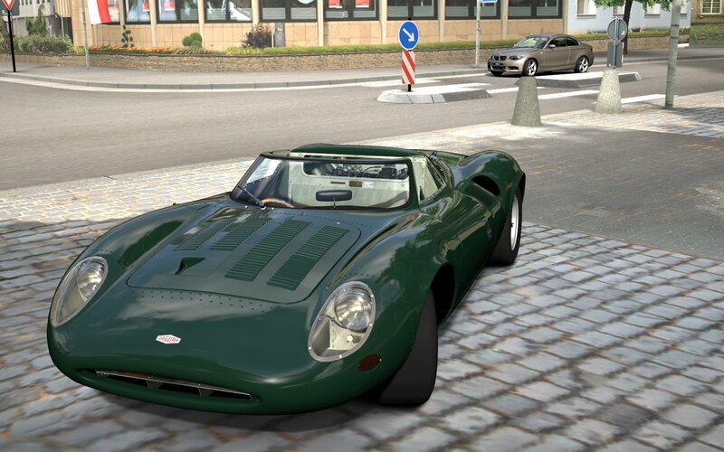 Green vintage race car on cobblestones