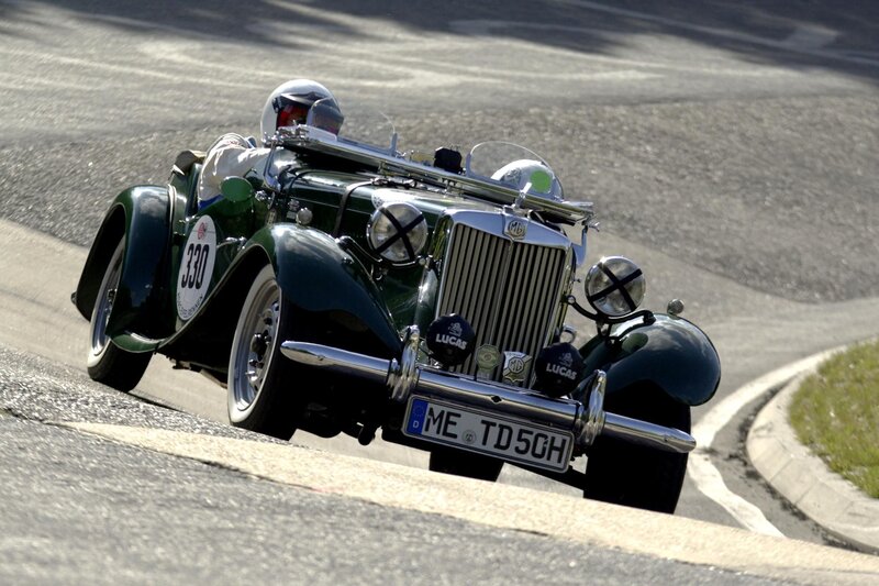 Green vintage race car on track