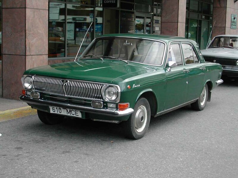 Green vintage sedan on street