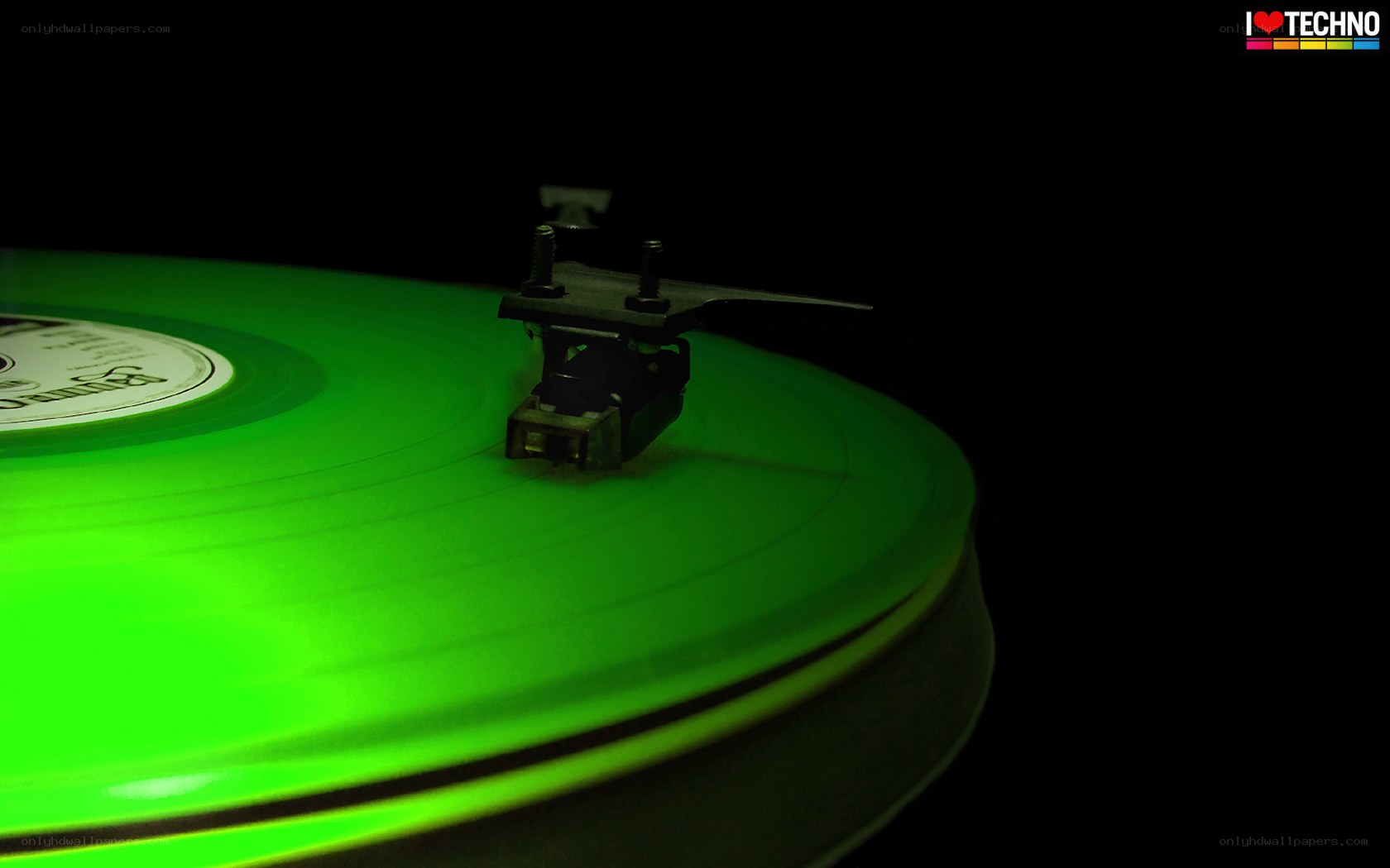 green vinyl record on turntable