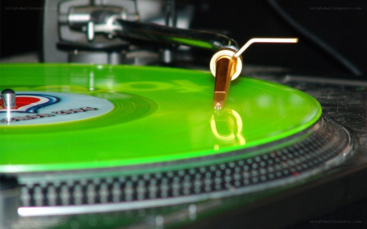 green vinyl record on turntable