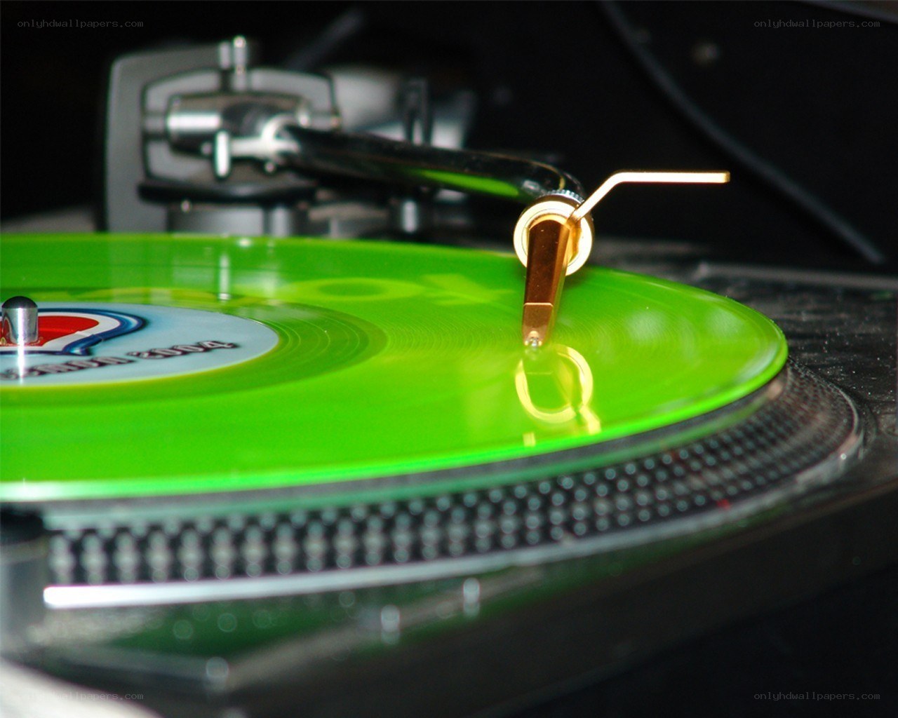 Green vinyl record on turntable