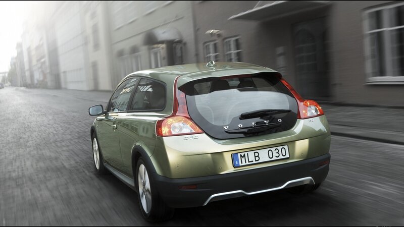 green volvo c30 driving