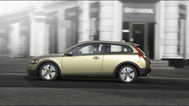 green volvo driving on city street