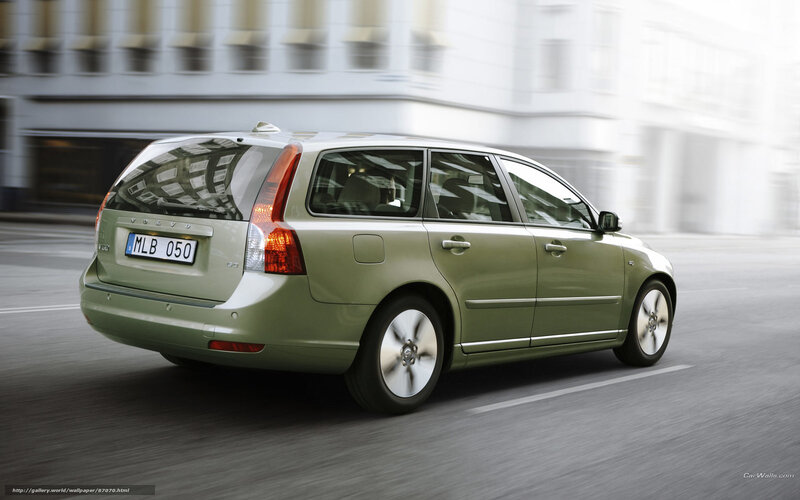 green volvo driving on city street