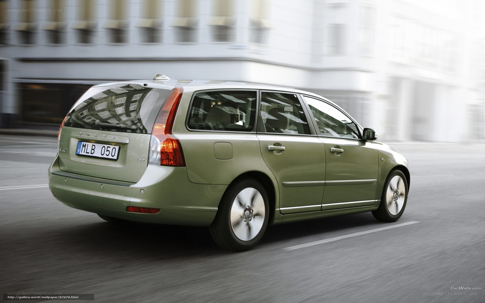 green volvo driving on city street
