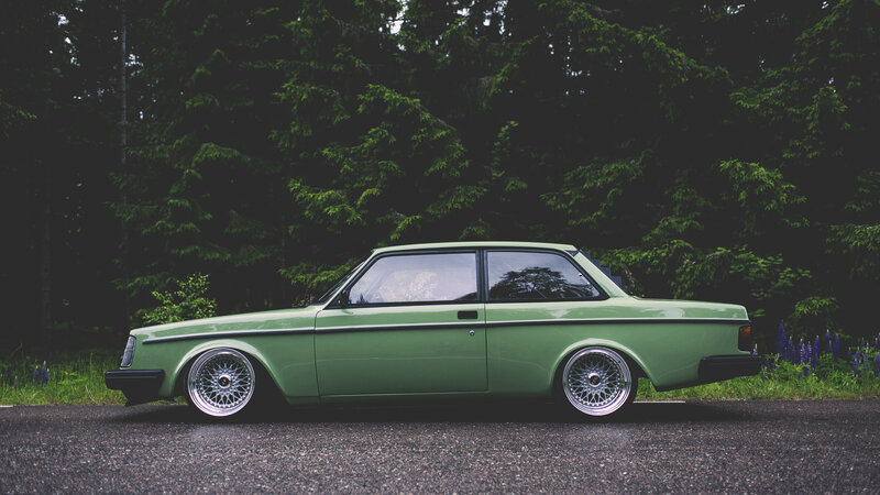green volvo in forest