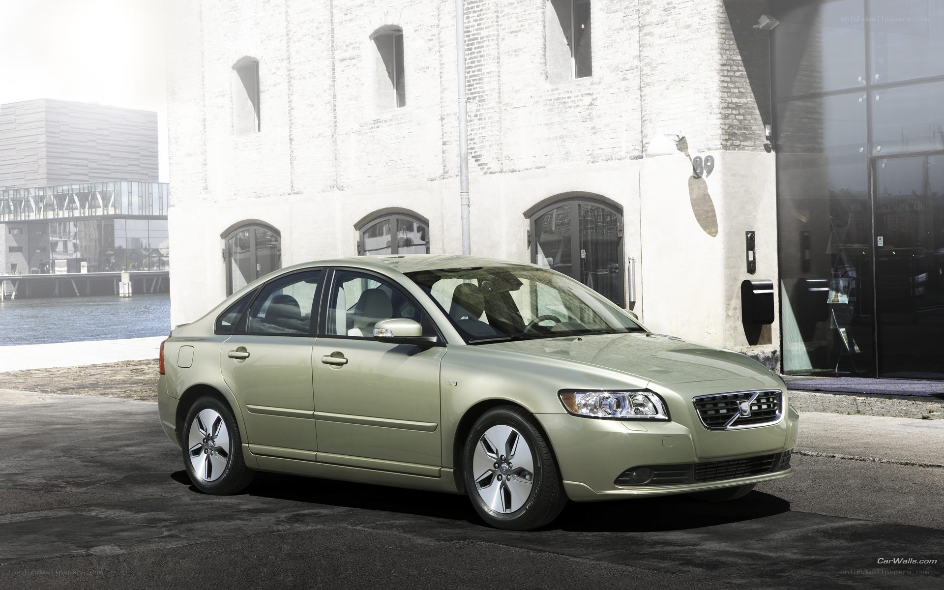 green volvo sedan in urban setting