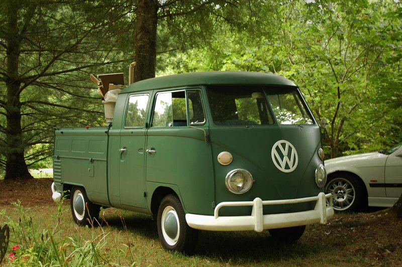 Green VW pickup in forest