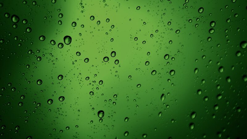 green water droplets on glass