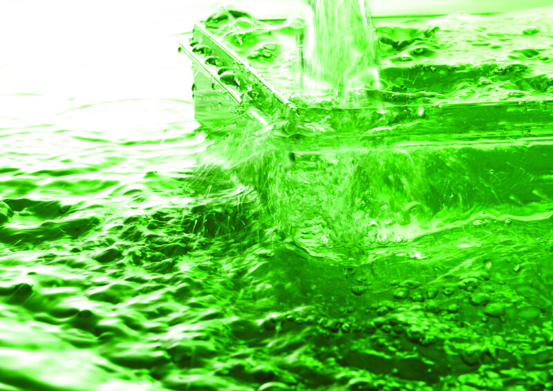 green water pouring into container