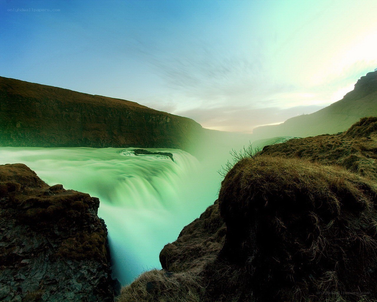 Green waterfall in a canyon