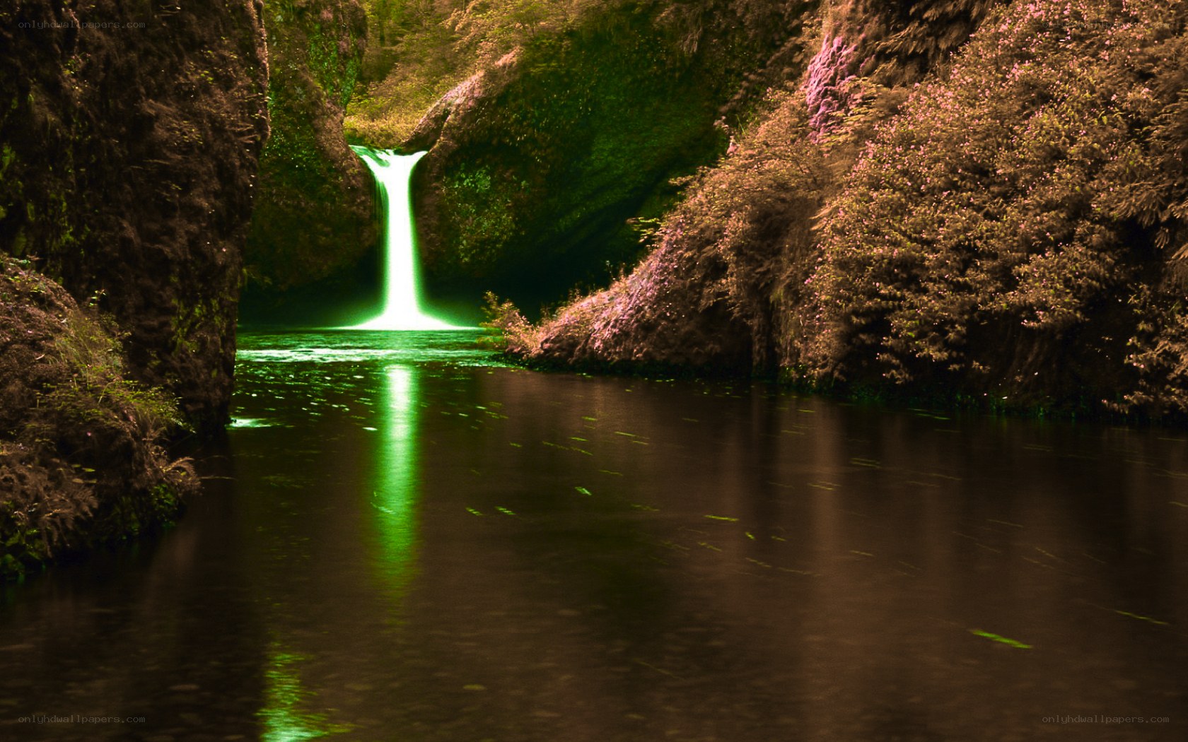 green waterfall in canyon