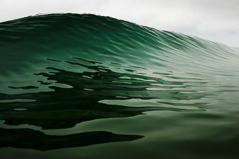 green wave forming in ocean