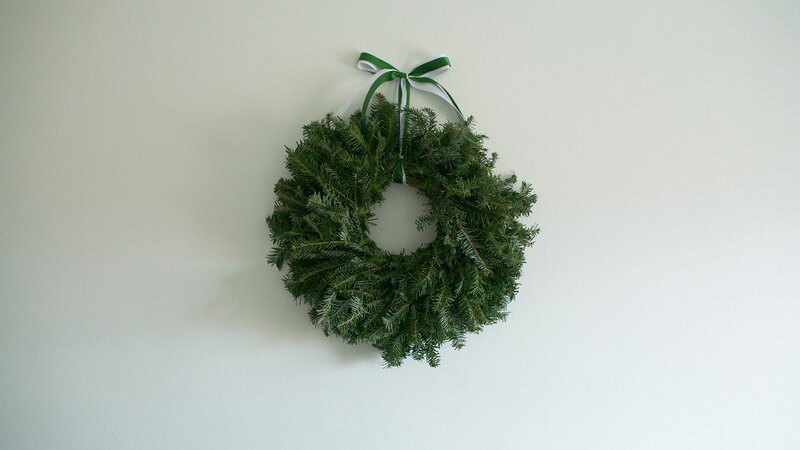 green wreath on white wall