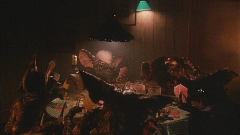 Gremlins playing cards at a table