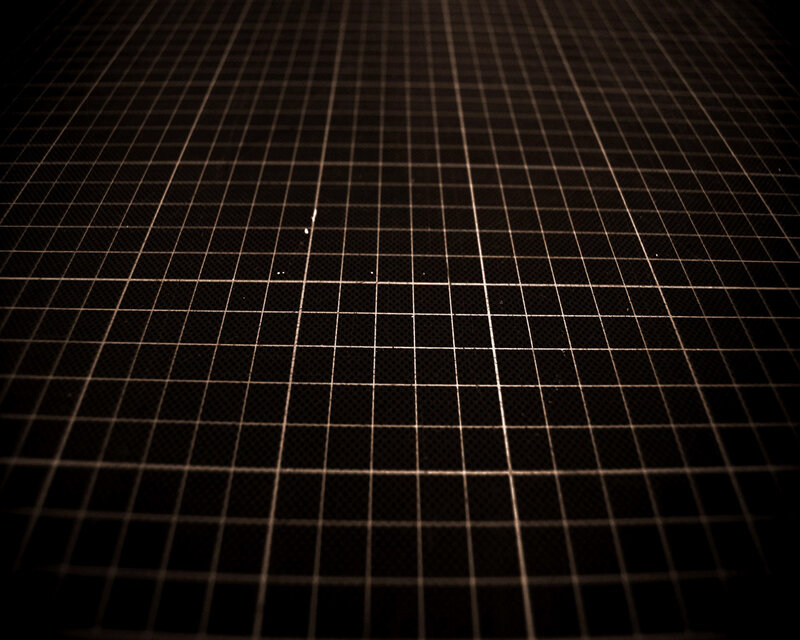 grid pattern on dark surface