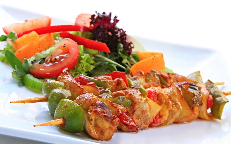 Grilled chicken skewers with salad